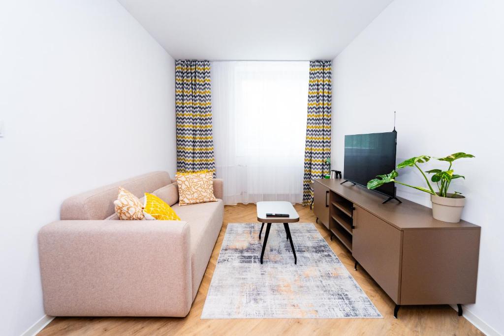 a living room with a couch and a flat screen tv at Turistická ubytovňa pri Spojenom školskom internáte Werferova 10 in Košice