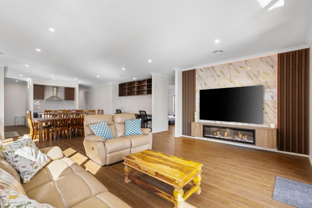 a living room with a couch and a fireplace at The Island Nirvana in Wimbledon Heights