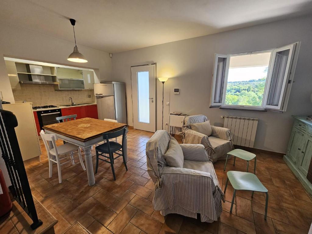 a kitchen and a living room with a table and chairs at A Casa Nostra in Montopoli in Val dʼArno