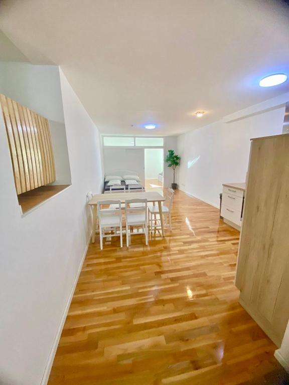 a kitchen and dining room with a table and wooden floors at Modern 2 Bedroom Apartment in Vienna