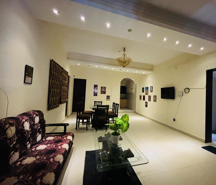 a living room with a couch and a table at Kamlam Homes- Bhowali Villa in Bhowāli