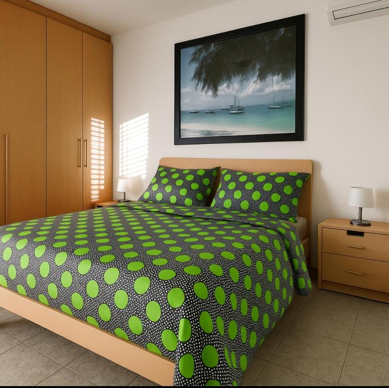 a bedroom with a bed with green polka dots at Affitti Brevi- MEDITERRANEO in Crotone