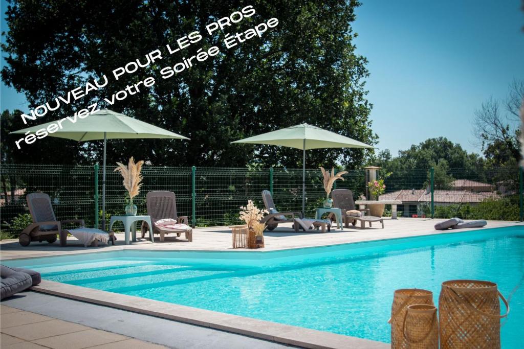 a swimming pool with chairs and umbrellas next to it at Ô DOMAINE DU ROUSSILLON in Saint-Nauphary