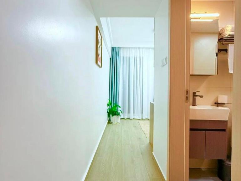 a hallway of a kitchen with a sink and a mirror at Hotel tarzan in Amritsar