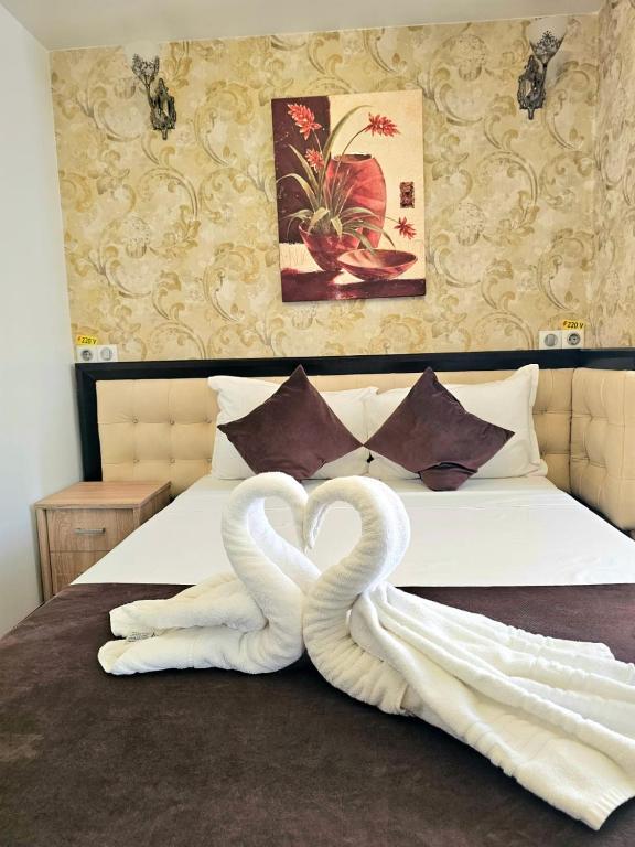 two swans made out of towels on a bed at Pensiunea Ghiocela in Motru