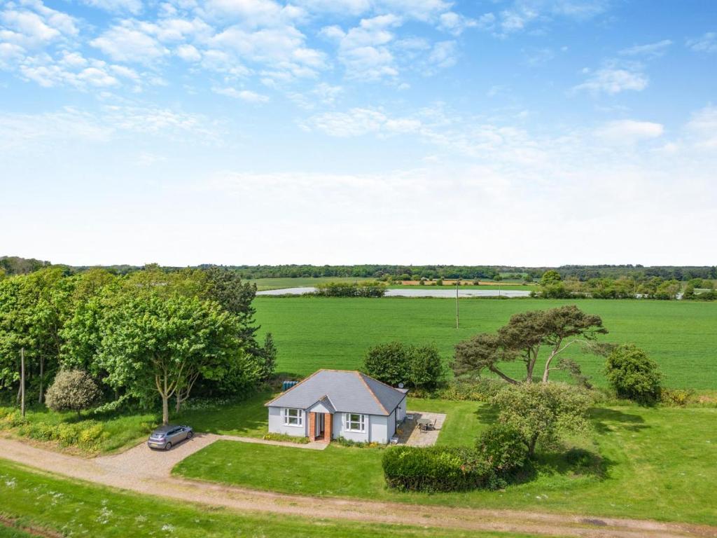 an overhead view of a small house in a field at Lodge Farm Cottage in Sudbourne