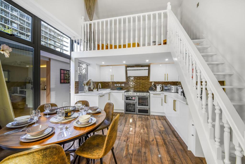 a kitchen and dining room with a table and chairs at London Lets Stay Here with parking in Ilford