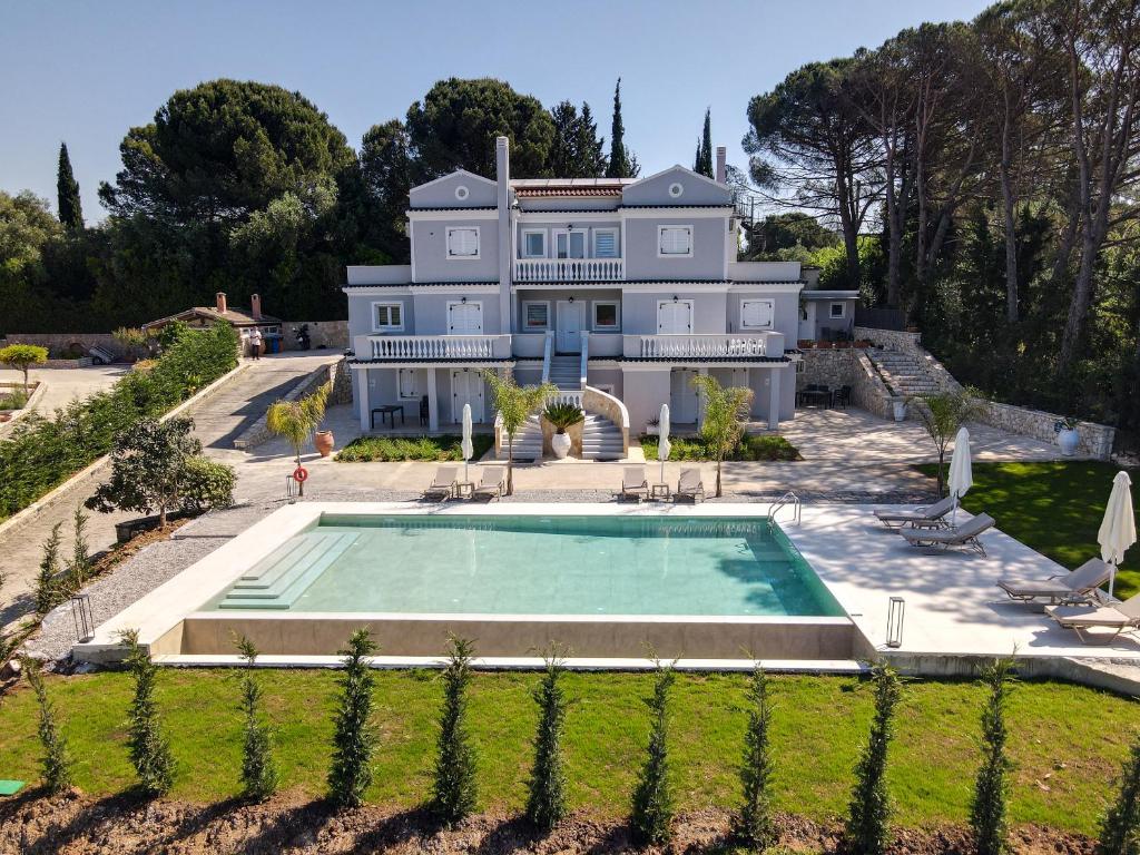 an aerial view of a large house with a swimming pool at The Seven Islands Deluxe Apartments in Gouvia