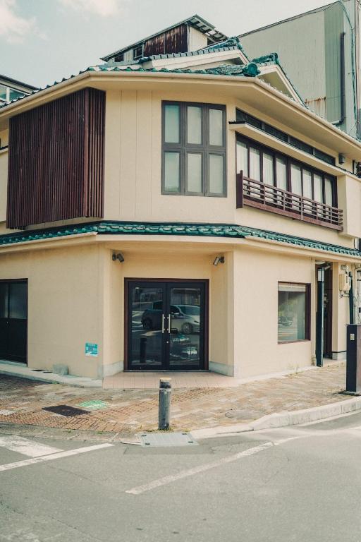 a house on the corner of a street at Chikotto Inn in Kumano