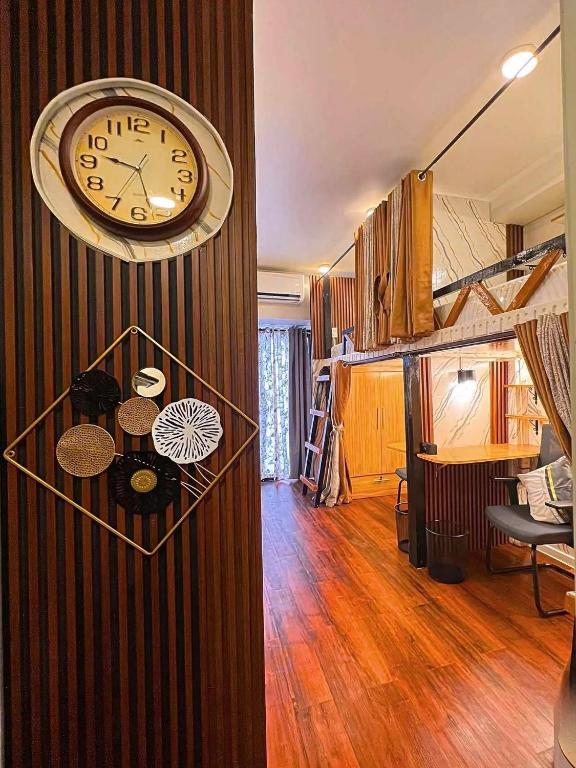 a clock hanging on a wall in a room at Davao Condo Bed Space - Safe, Affordable & Comfy in Davao City