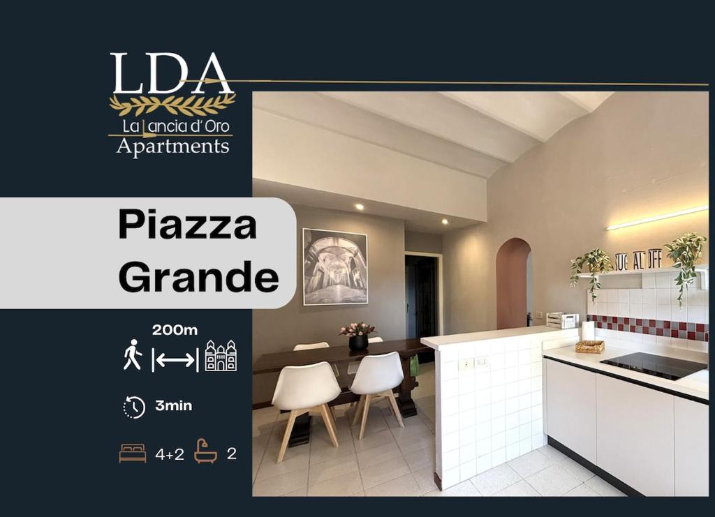 a kitchen with a table and chairs in a room at La Lancia D'Oro in Arezzo