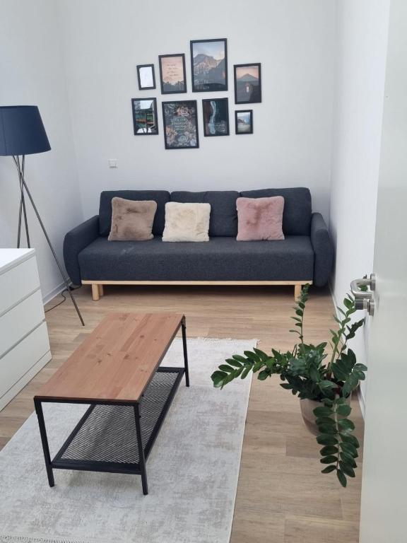a living room with a blue couch and a coffee table at L8 Street - Mönsheim in Mönsheim