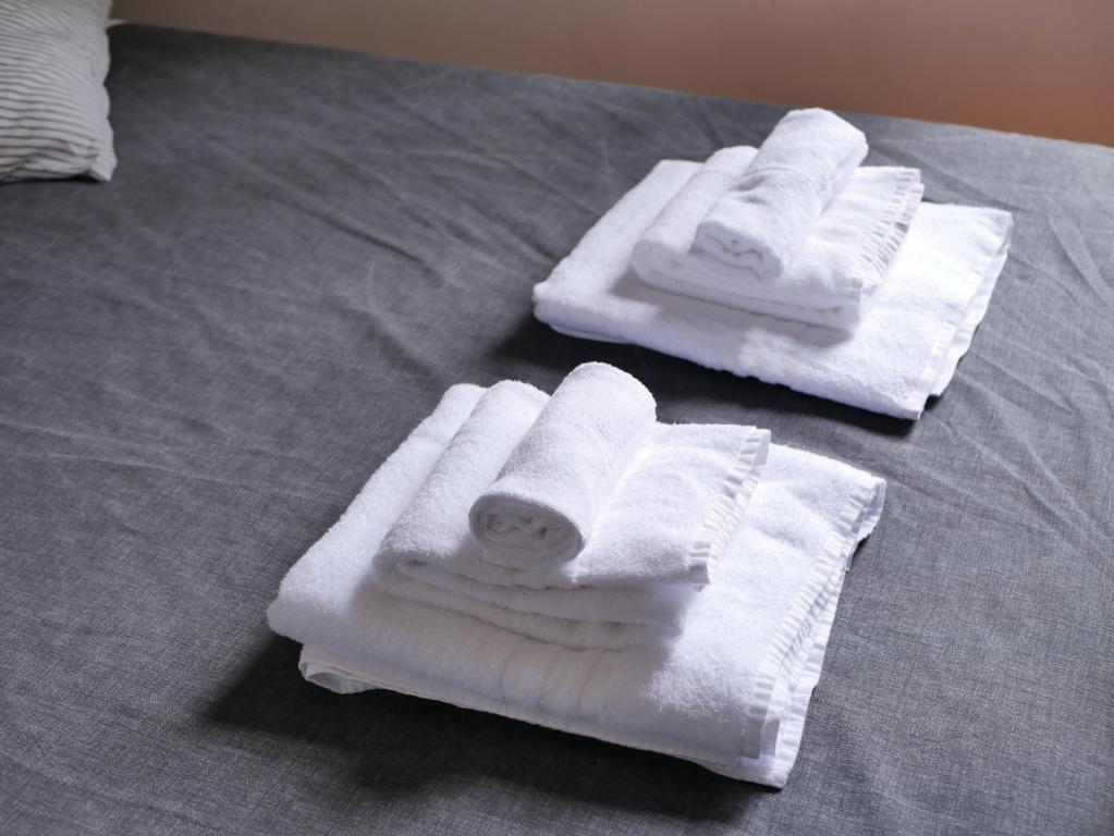 two towels sitting on top of a bed at Rooms Piramide in Rome
