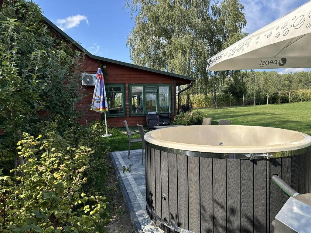 a jacuzzi tub in the backyard of a house at Cicha Kolonia Krupicka in Krupice