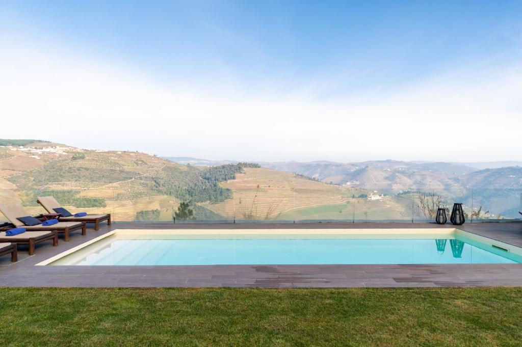 a swimming pool with a view of the mountains at Spacious Villa with Private Pool & Garden in Douro, by Hopstays in Sabrosa
