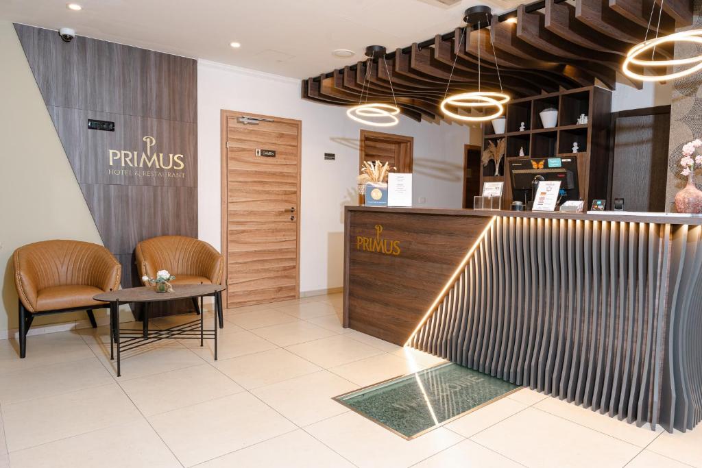 a restaurant with a table and chairs and a counter at Primus Hotel & Apartments in Vienna