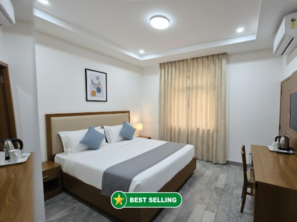 a hotel room with a bed and a desk at V - PREMIUM R - GH - Varanasi - Free Wi-Fi & Parking - Near The Holy Kashi Vishwanath Temple! in Varanasi