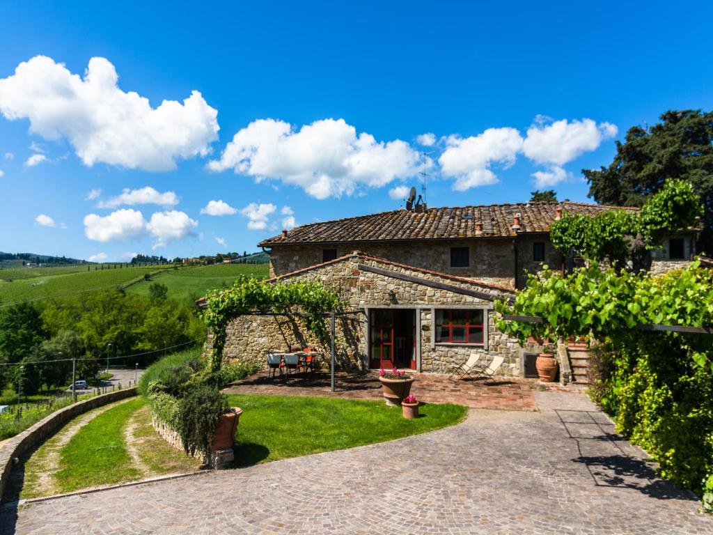 an exterior view of a stone house with a garden at Tuscan Charm in Greve in Le Bolle