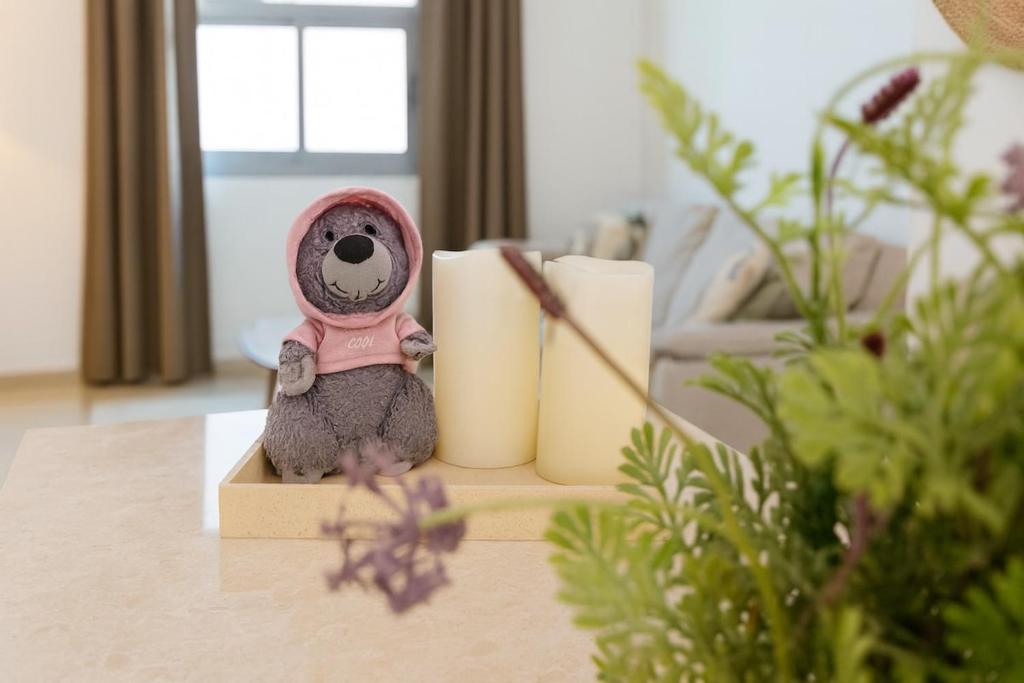 a small teddy bear sitting on a table at Cozy 1BR with Sofa Bed Walk to JBR & Marina in Dubai Marina