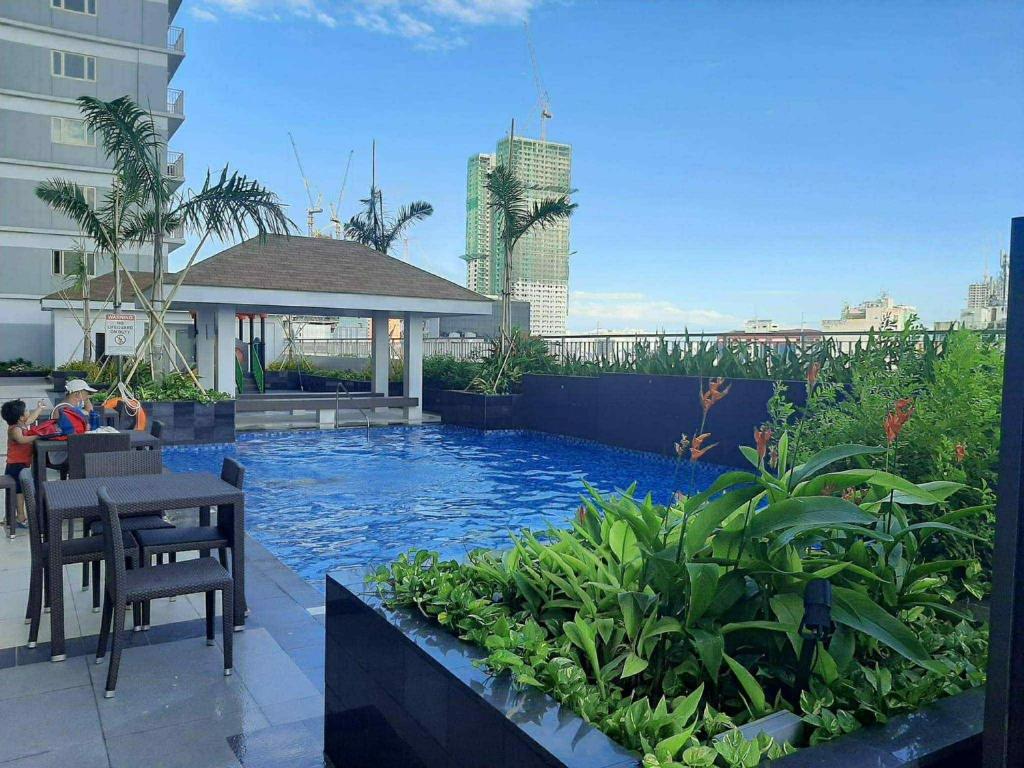 a swimming pool in the middle of a building at Modern Comfort in Pasay with Pool in Manila