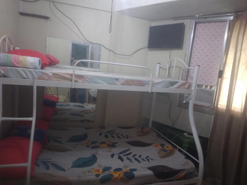 Ένα ή περισσότερα κρεβάτια σε δωμάτιο στο Quickshape Homestay