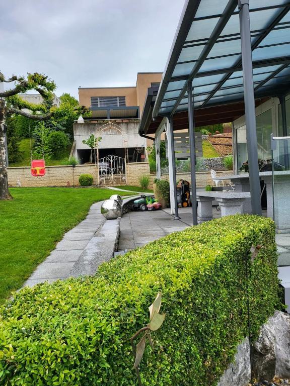 a bird on a bush in front of a house at 5,5 pc apartment, garden but Pool only upon request in Avry