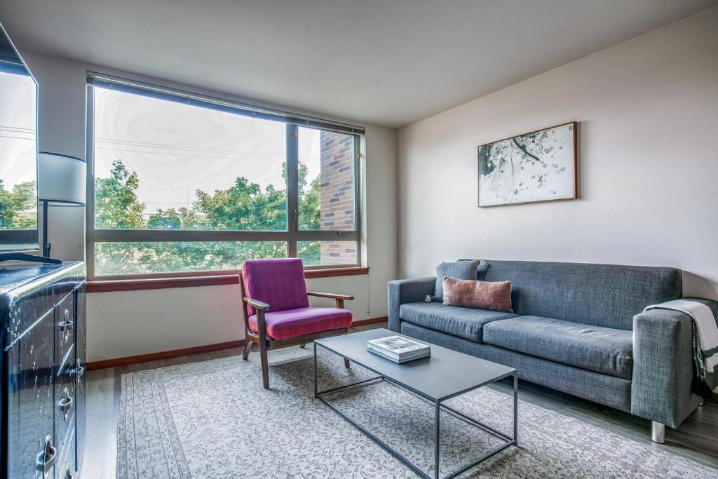 a living room with a couch and a table at Blueground Brighton balcony nr Othello Park SEA-875 in Seattle