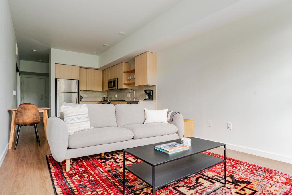 a living room with a white couch and a table at Blueground Downtown rooftop nr Marymoor Park SEA-890 in Redmond