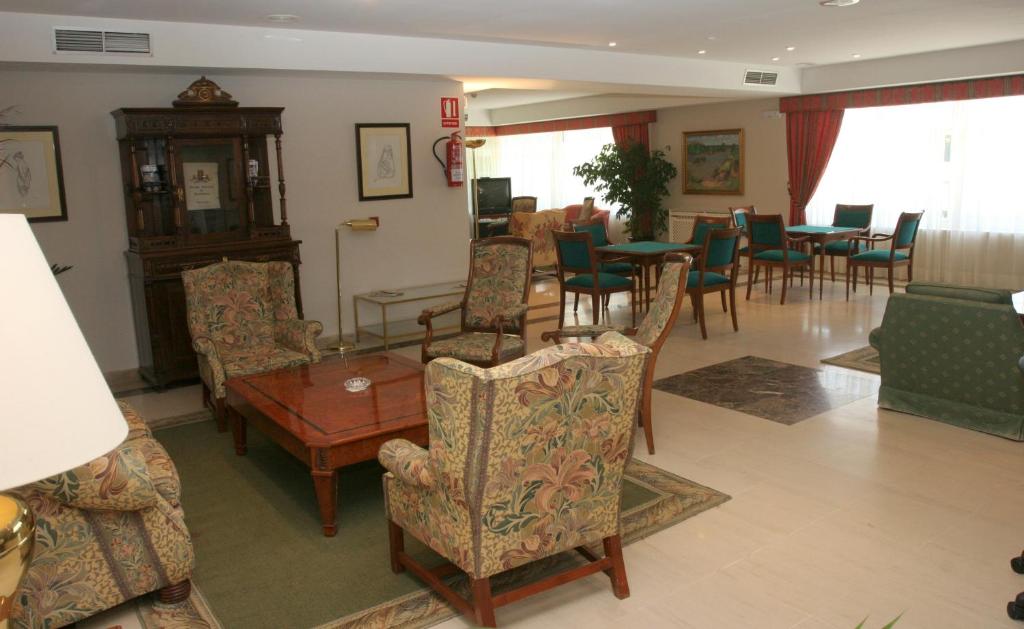a living room filled with furniture and a table at Pousada de Portomarín in Portomarin