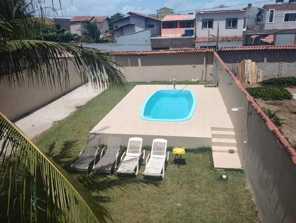 an overhead view of a swimming pool with two lounge chairs and a swimming pool at Casa Faé in Guarapari