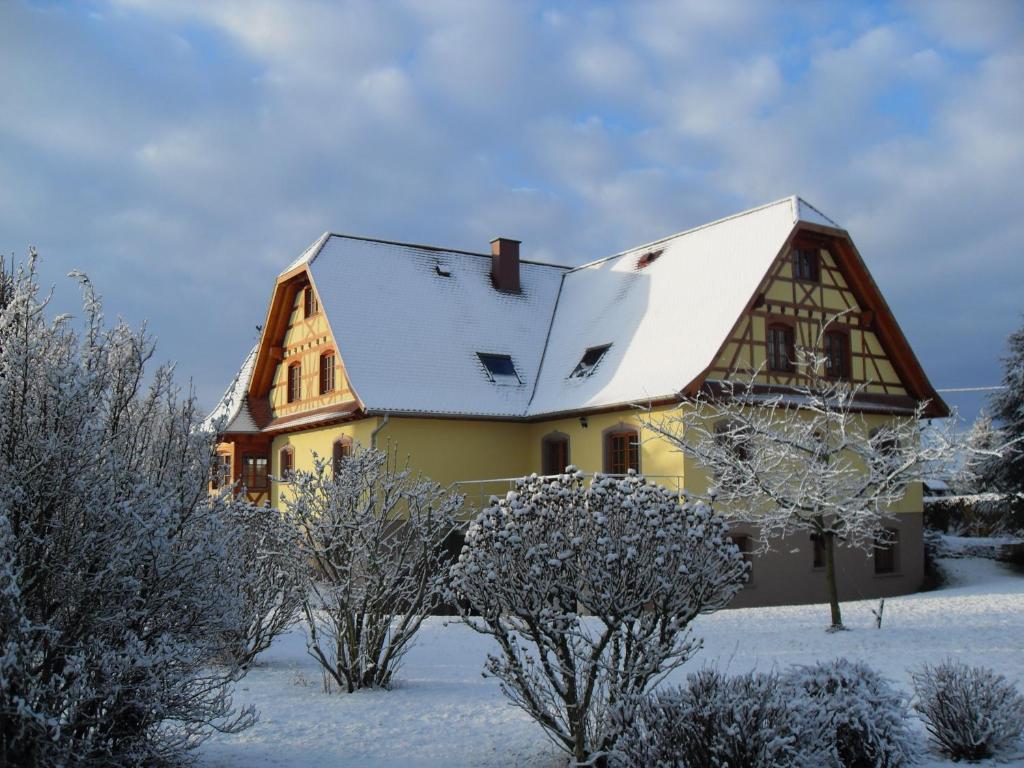 a house with a snow covered roof at Maison d'hôtes Chez Christelle - Proximité Route des vins d'Alsace in Griesheim-près-Molsheim