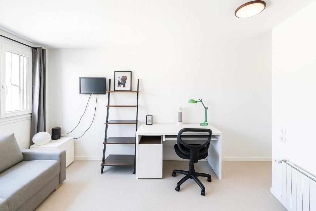 a living room with a desk and a chair at Small functional cocoon Ideal solution for students or professionals in Vaise