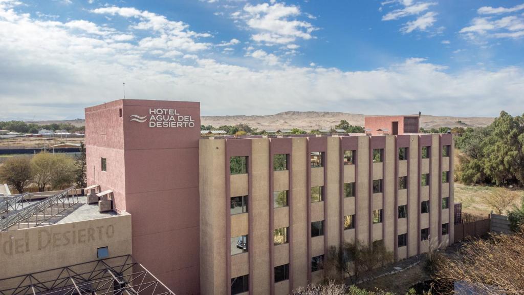 a building with a sign on the side of it at Hotel Agua del Desierto in Calama