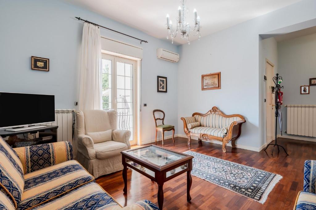a living room with a couch and a table at GuestHost - Trecastagni Elegant & Comfy Apartment in Trecastagni
