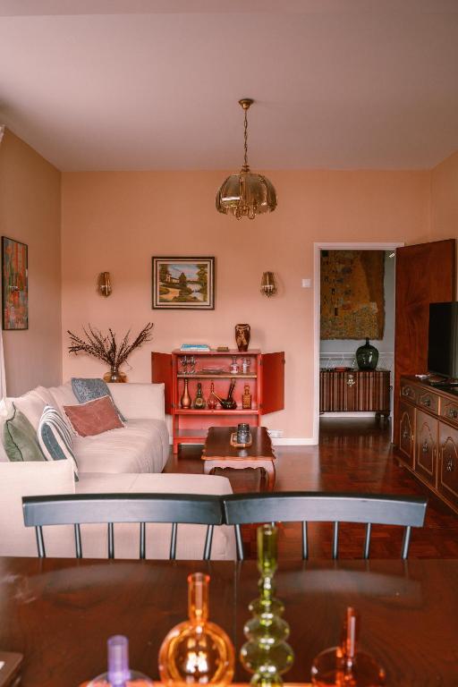 a living room with a bed and a table at Casa d'Avo - 3BD cosy home in Funchal