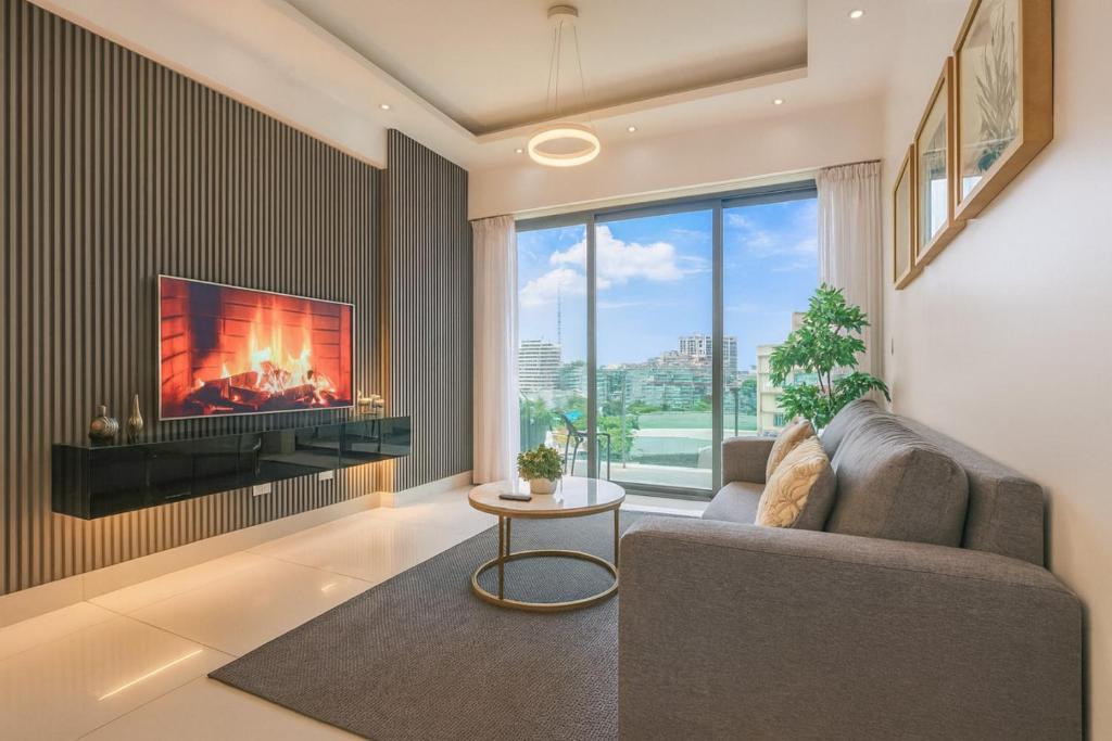 a living room with a couch and a tv at Upscale Condo, Spectacular Views in Santo Domingo