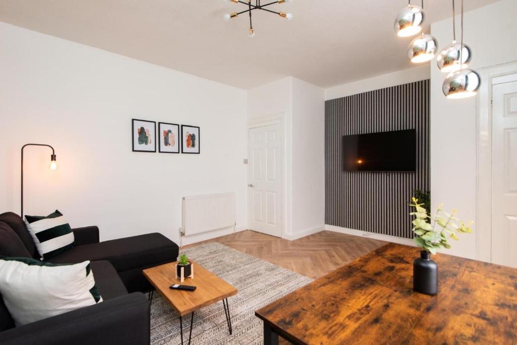 a living room with a couch and a table at Northcote apartment in Hawick