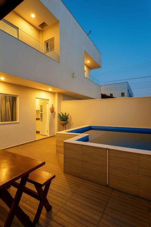 a house with a swimming pool in the middle of a room at Bahia Bela - Casa Duplex 02 in Santa Cruz Cabrália