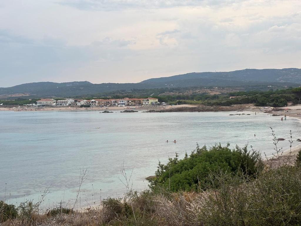 a beach with people swimming in the water at Casa Carboni in Vignola Mare
