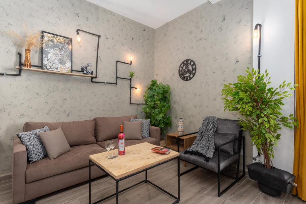 a living room with a couch and a table at Phenom 1-Bedroom Apartment in Mar Mikhael in Al Mudawwar