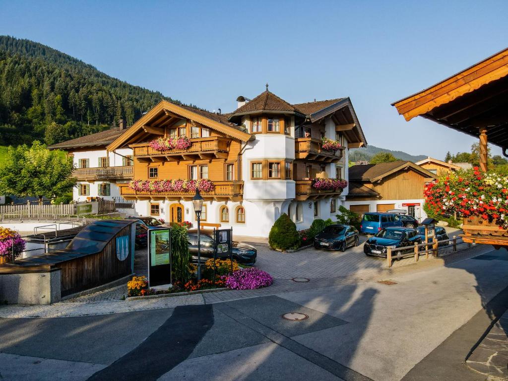 a large building with flowers in front of it at Gästehaus Brantlhof Zimmer und Ferienwohnungen in Going am Wilden Kaiser in Going am Wilden Kaiser