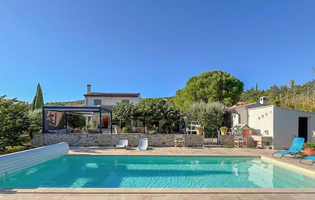 a swimming pool in front of a house at Awesome Home In Brignoles in Brignoles