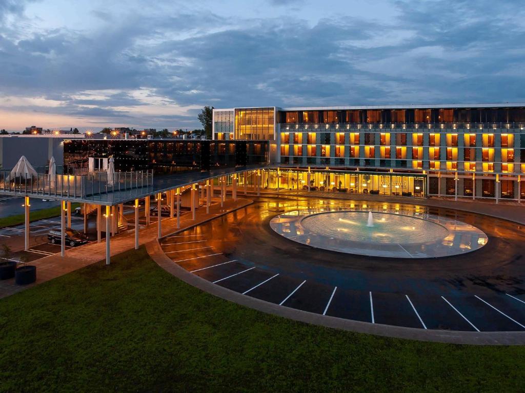 un grand bâtiment avec une fontaine devant lui dans l'établissement Mercure Tallinn, à Tallinn