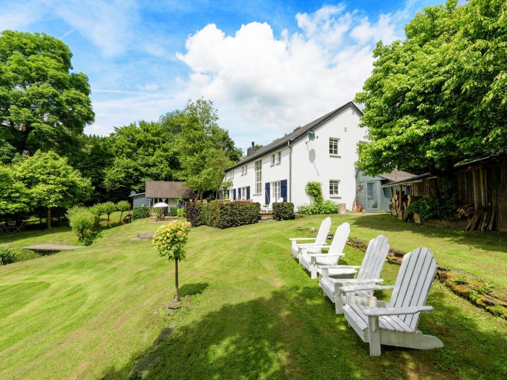 a row of white chairs sitting in a yard at Peace, Nature & Comfort Combined in Cetturu