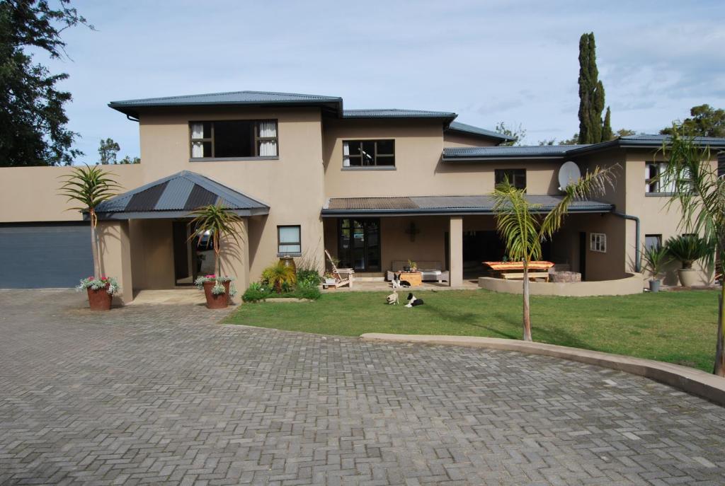 a house with a brick driveway in front of it at 15 Witpeer Street Guesthouse in George