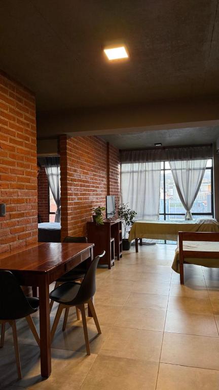 a living room with a table and chairs and a couch at TempoJUY in San Salvador de Jujuy