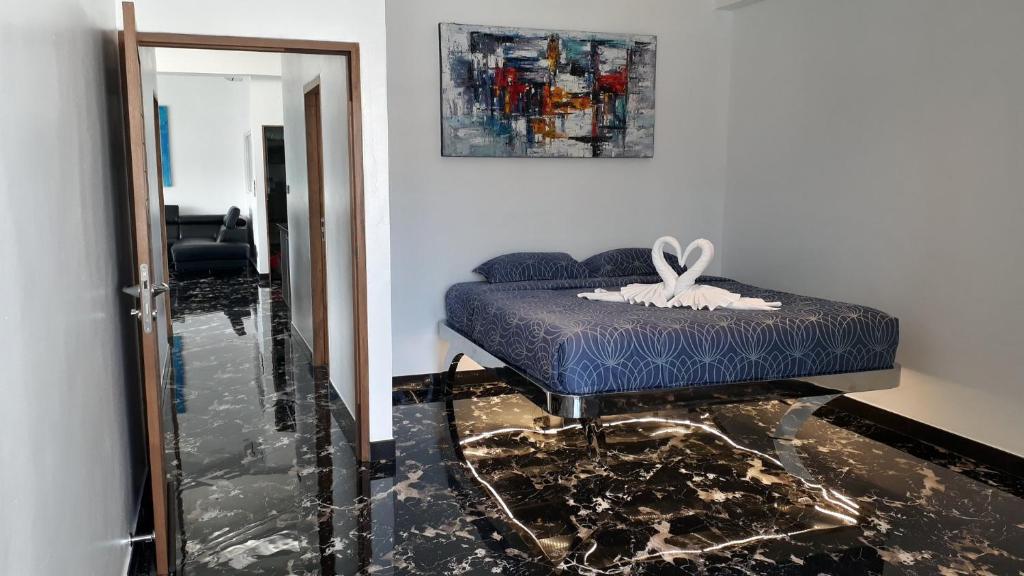 a bedroom with a blue bed and a mirror at PATONG TOWER SPACIOUS FAMILIES APARTMENT with 2 BATHROOMS 3&4 BEDROOMS Pta in Patong Beach