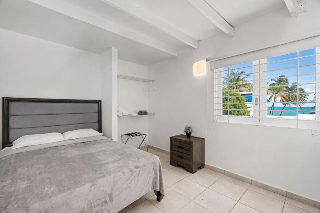 a bedroom with a large bed and a window at Coastal Paradise With Pool And Ocean Access in San Juan