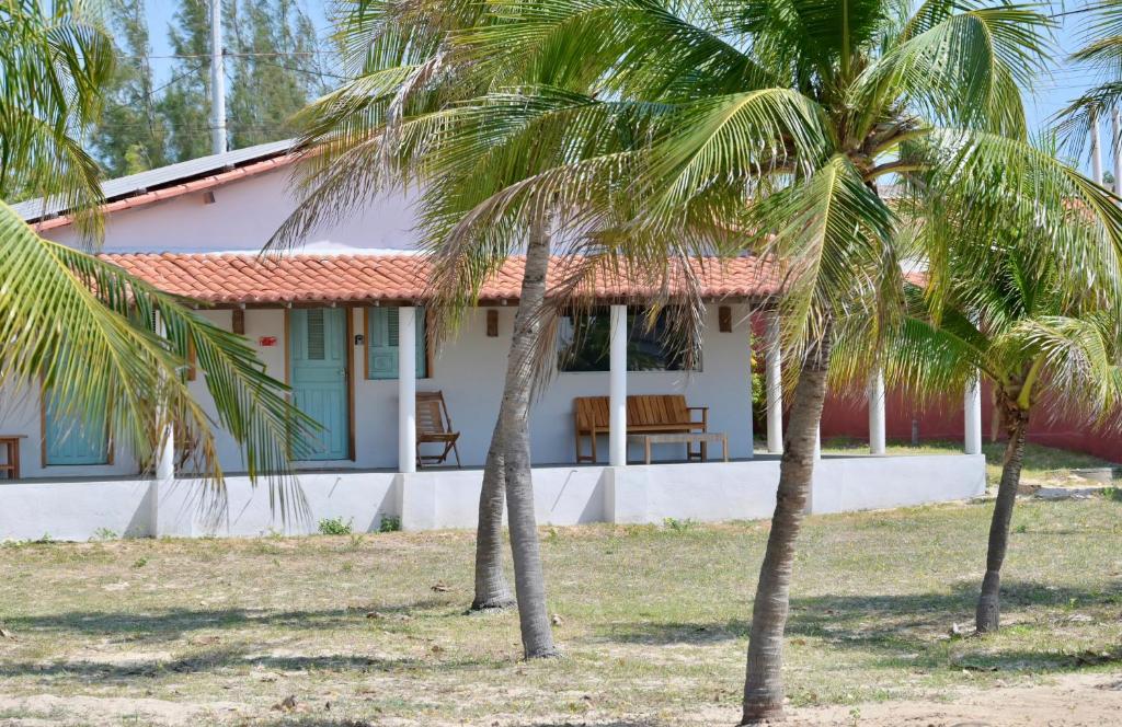 una casa con due palme di fronte di Flor - Private room with shared bathroom a Luis Correia