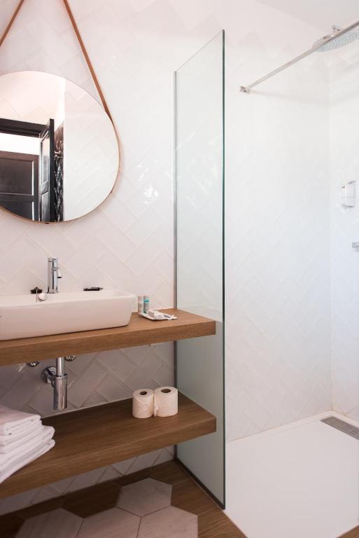 a bathroom with a sink and a mirror at Los Cardones Boutique Village in Playa de las Americas